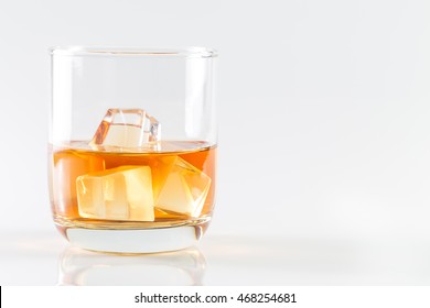 Wiskey In Glass With Ice On White Background