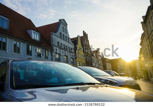 WISMAR,\
GERMANY - SEPTEMBER 23, 2019: luxury modern Cars For Sale Stock Lot\
Row. Car Dealer Inventory. Cars For Sale Stock Lot Row. Car Dealer\
Inventory. sunset sun rays light. sun\
beam