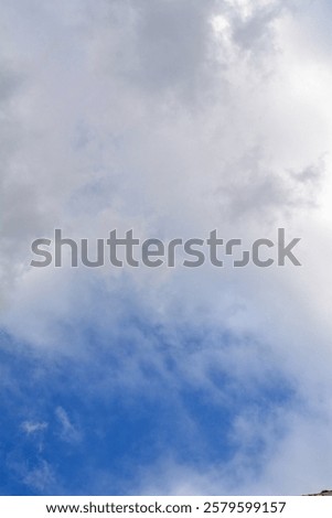 Wispy clouds float gracefully in the endless sky.