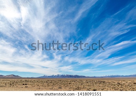 Wispy clouds over a vast desert landscape, along the Extraterrestrial Highway in Nevada