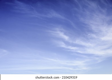 Wispy, Thin Cirrus Clouds Against Blue Sky