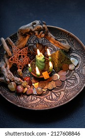 Witch altar with candles, different coins, stone runes, pentacle on dark table background close up.  Magic for attracting money, wealth. witchcraft money esoteric ritual. occultism concept. top view