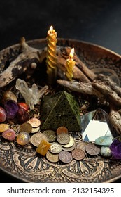 Witch altar with candles, different old coins, stone runes, crystals on dark table background close up. Magic for attracting money, wealth. witchcraft money esoteric ritual. occultism concept
