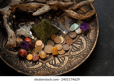 Witch altar with old coins, stone runes, crystals on dark table close up. Magic for attracting money, wealth. witchcraft. spiritual esoteric ritual for rich life. money magic.
