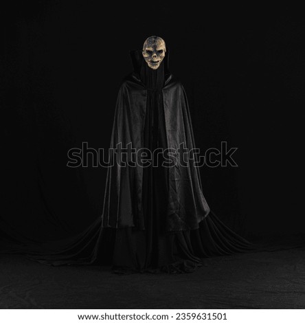 witch in a black cloak on a black background