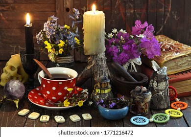 Witch Books, Cup Of Tea, Runes And Burning Candles On The Table. Esoteric, Wicca And Occult Background With Magic Objects, Fortune Telling And Divination Ritual, Halloween Mystic Background. 