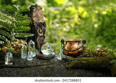 witch cauldron, wiccan Goddess ritual figurine and quartz crystals in forest, natural background. esoteric spiritual practice. crystal magic, witchcraft. esoteric spiritual ritual. mystery atmosphere