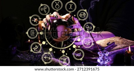 Witch with crystal ball at dark table, closeup