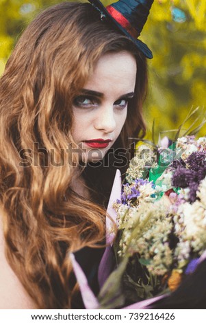 Witch with dried flowers close-up