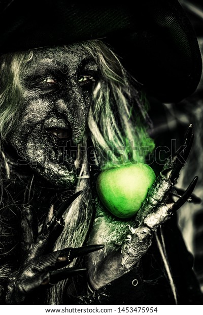 Witch Holding Apple Halloween Horror Movie Stock Photo (Edit Now
