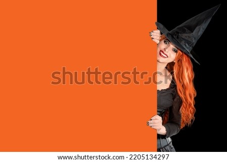 Witch on Halloween. Female wizard fairy character for All Saints' Day. Fantasy gothic red-haired Vampire girl in black dress carnival costume. Enchantress woman sorceress.