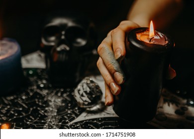 A witch performs a magic ritual with candles 
