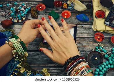 Witchcraft in the photo. reading the human aura. Female hands doing magic with photo. The witch and magic. seance. Paranormal abilities. Love spells and charms. - Shutterstock ID 1658958526