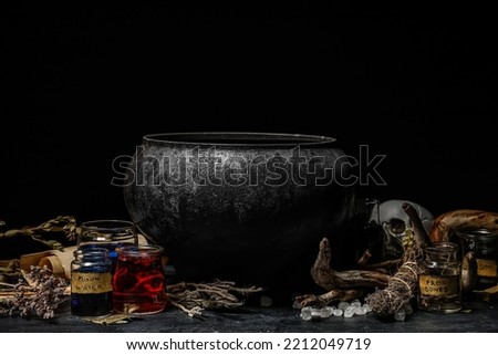Witch's cauldron and magic attributes for ritual on dark background