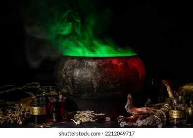 Witch's cauldron with potion and magic attributes for ritual on dark background