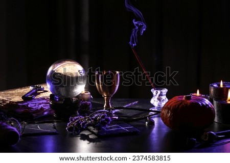 Witch's magic attributes on dark table, closeup