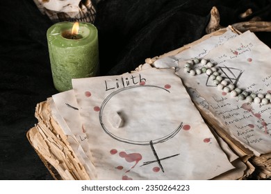 Witch's magic attributes with spell book on dark table, closeup