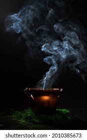 The Witch's Smoking Cauldron On Dark Background.