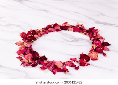 Withered Red Rose Petals Arranged In A Circle On A Table