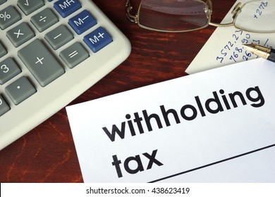Withholding tax written on a paper.  - Shutterstock ID 438623419