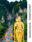 Within the mountainous Kuala Lumpur city outskirts.Limestone caves at the top of steep multi-colored steps,housing Hindu temples,shrines,and a huge golden deity statue seems to guard the entrance.