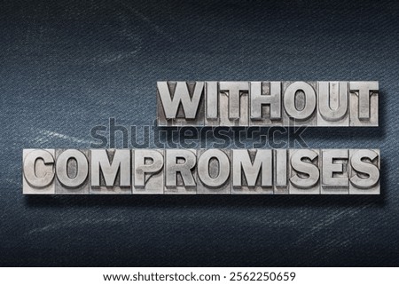 without compromises phrase made from metallic letterpress on dark jeans background