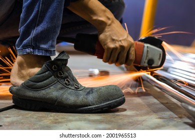without safety gloves at work. Construction workers do not wear gloves and safety shoes to work. Workplace is not safe. Close up hand worker electric saw wheel grinding cutting
 a steel in factory.  - Shutterstock ID 2001965513
