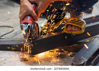 without safety gloves at work. Construction workers do not wear gloves and safety shoes to work. Workplace is not safe. Close up hand worker electric saw wheel grinding cutting
 a steel in factory.  - Shutterstock ID 2074003046