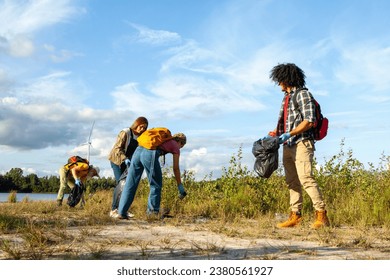 Witness the empowering camaraderie of diverse young volunteers uniting for a cause. Amidst the verdant forest, they toil together, garbage bags in hand, their faces lit with determination and shared - Powered by Shutterstock