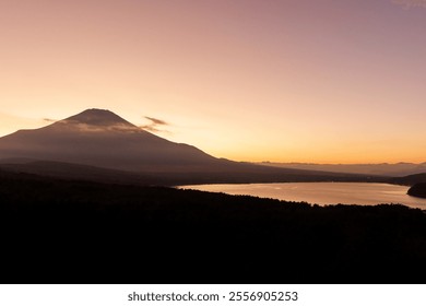 Witness the Majestic Sunrise illuminating the Fuji Mountain near the Calm Lakes shores. - Powered by Shutterstock