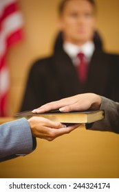 Witness Swearing On The Bible Telling The Truth In The Court Room