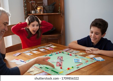 Witney, Oxfordshire, UK 02 03 2020 A Family Playing Monopoly