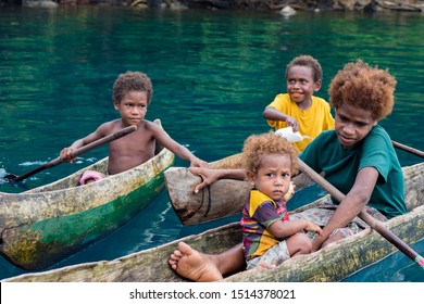 Witu Islands, Papua New Guinea - September 23rd 2019 - Local Children From Village In Their Wooden Canoes 