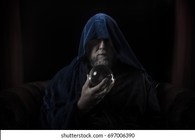 Wizard With Beard And Blue Robe Holding Crystal Ball