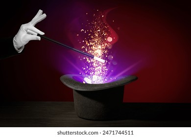 Wizard conjuring magical light out of hat with wand on dark background, closeup