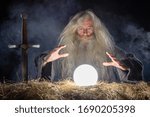 Wizard looking in crystal ball to predict future
