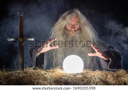 Wizard looking in crystal ball to predict future