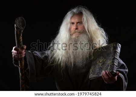 A wizard with a magical ancient book of spells	