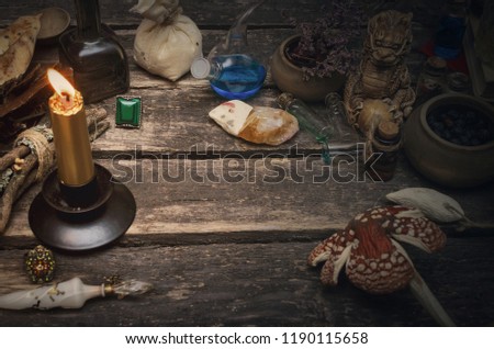 Wizard table with various magic accessories and ingredients. Witchcraft. Herbal alternative medicine.