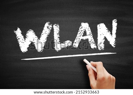 WLAN - Wireless Local Area Network is a wireless distribution method for two or more devices, acronym text concept on blackboard