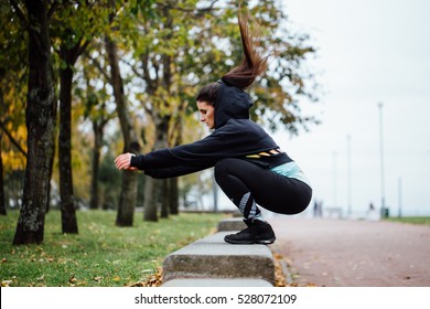 Wman in functional training outdoor at park doing fitness exercise. Sporty girl doing jumps. - Powered by Shutterstock