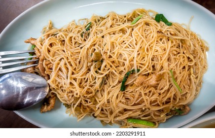 Wok fried rice vermicelli noodles with lean juicy chicken pieces. Strips of green onions (shallots) completes the dish. Simple and healthy meal as a catering concept. - Shutterstock ID 2203291911