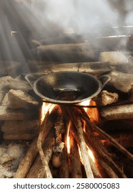 Wok on fire.A culinary dance of fire and metal, as a wok is engulfed in flames, stirring up the promise of a delicious meal.