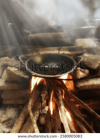 Wok on fire.A culinary dance of fire and metal, as a wok is engulfed in flames, stirring up the promise of a delicious meal.