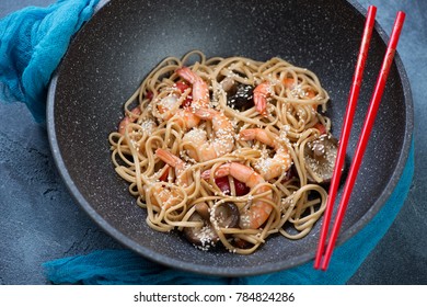 Wok Pan With Stir-fried Udon Noodles And Tiger Shrimps, Selective Focus, Studio Shot