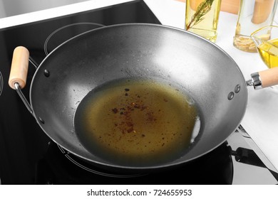 Wok With Used Vegetable Oil On Stove