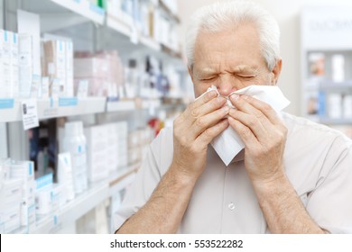 Woke Up Sick. Close Up Shot Of A Senior Man Blowing His Nose Into Paper Napkin At The Pharmacy Flu Cold Sickness Sick Allergy Allergies Hygiene Medicine People Concept Copyspace