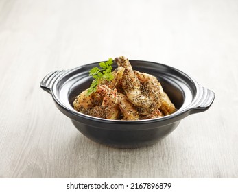 Wok-fried Prawns With Salt And Pepper With Chopsticks Served In A Pot Isolated On Mat Side View On Grey Background