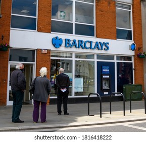 Wokingham, United Kingdom - June 05 2020:  Shoppers Queuing Outside The Branch Of Barclays Bank On Peach St