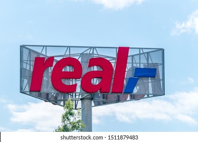 Wolfsburg, Germany - June 8, 2019: Logo And Sign Of Real Shop. Real (stylized Real) Is A Chain Of Hypermarkets In Germany, Member Of The German Retailer Metro AG.